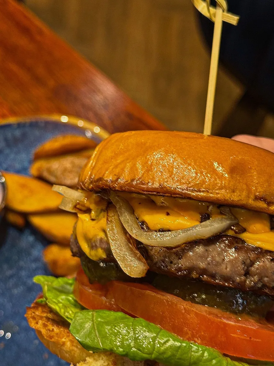 Burger topped with onions and cheese